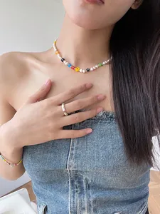 Elegant colorful beaded flower necklace with irregular pearls shown on a model