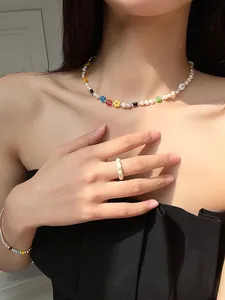 Colorful beaded flower necklace with pearls and matching jewelry set worn by a model