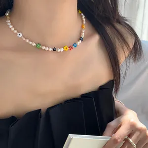 Close-up of sweet colorful flower beaded pearl choker necklace on Asian model's neck