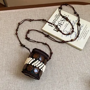 Detailed view of bohemian ethnic necklace crafted from coconut shells and white beads
