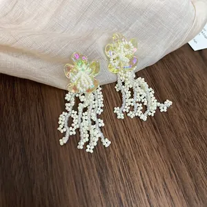 Yellow flower stud earrings with elegant white beaded tassels for a fresh summer look