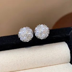 Elegant flower cluster stud earrings with white pearls and zircons in minimalist style.