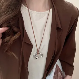 Minimalist vintage silver abstract pendant necklace with brown adjustable leather cord