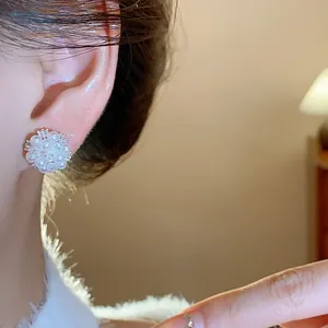Detailed close-up showing the elegant pearl and zircon flower cluster stud earrings