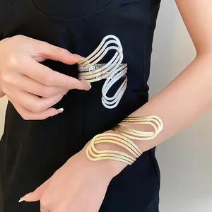 Close-up detail showing golden and silver textured geometric irregular cuff bracelets for women