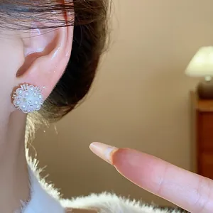 Detailed view of elegant silver pearl flower cluster earrings with sparkling zircons