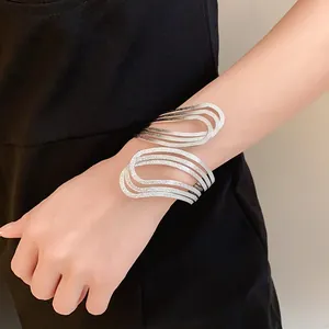 Detail showing the intricate hollow texture of a silver geometric open cuff bracelet