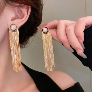 Elegant gold long metal tassel earrings with pearl and black stone detail for women