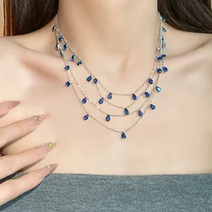 Detalle de elegante collar de varias capas con circonitas azules de gota