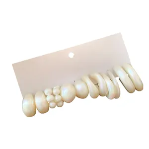 Elegant cream white acrylic earring set with pearl finish and geometric hoop designs