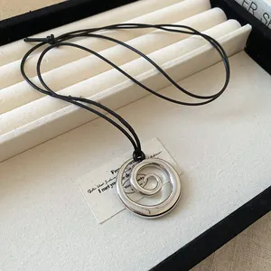 Minimalist silver spiral pendant necklace with adjustable black leather cord, sku variant