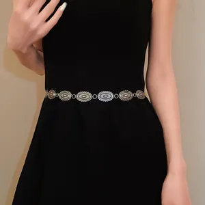 Close-up of vintage ethnic silver metal carved oval link waist chain belt