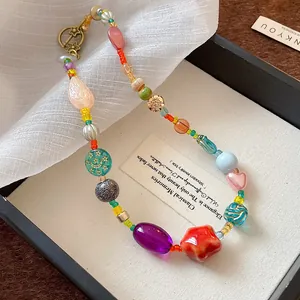 Detailed shot of colorful dopamine-style necklace with ceramic and glass beads