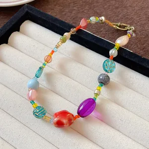 Detailed macro view of a colorful dopamine style necklace featuring ceramic and glass beads