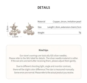 Close-up detail of star zircon earrings with pearls showing material and dimensions