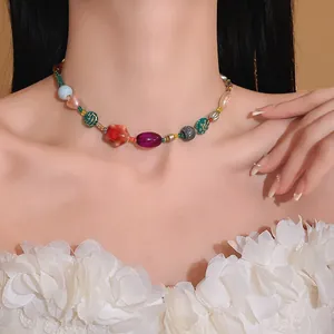 Close-up of a colorful dopamine-style necklace with ceramic and glass beads on a model