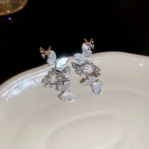 Luxurious silver butterfly tassel drop earrings with shell inlay and sparkly rhinestones