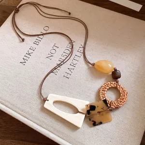 Bohemian handmade rattan and wooden bead necklace with geometric acetate pendants