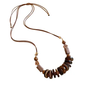 Bohemian ethnic vintage wooden bead necklace with adjustable brown cord for women.