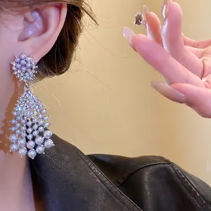 Vintage silver needle drop earrings with layered pearls and sparkling rhinestones
