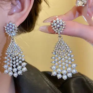 Elegant close-up detail of French vintage waterdrop earrings with pearls and rhinestones
