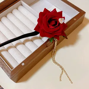 Detailed shot of vintage red rose hair stick with rhinestone heart and crystal tassel.