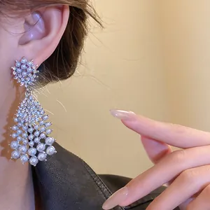 Elegant French retro pearl and rhinestone water drop tassel earrings worn by a model