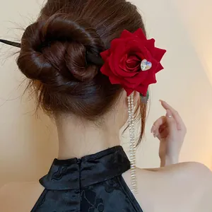 Vintage red rose hair pin with heart crystal and long pearl tassels shown on bun.