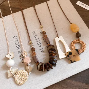 Detailed macro view of Bohemian handmade necklaces with wood beads and natural rattan weaving.