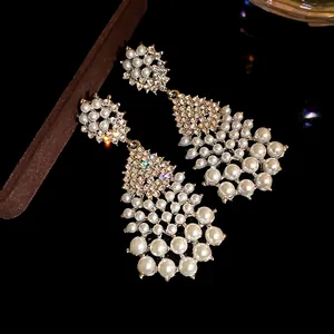 Detailed view of vintage French court style earrings with pearls and sparkling crystals.