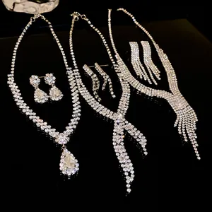 Selection of elegant silver-tone rhinestone necklace and earring sets for wedding parties.