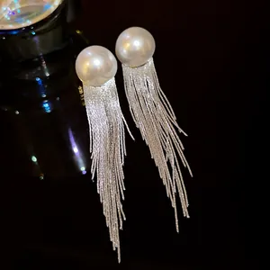Elegant long tassel drop earrings with large white pearls and silver fringe design