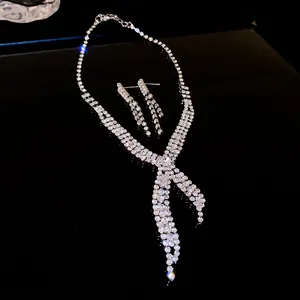 Detail view of a sparkling rhinestone tassel necklace and earrings set in silver finish