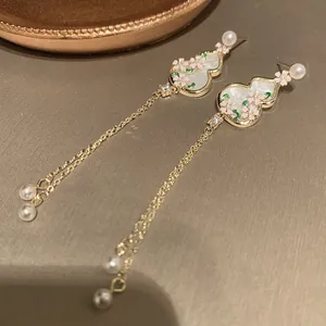 Close-up of elegant New Chinese style gourd earrings with pearl tassels and flowers