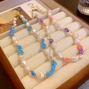 Close-up detail of three gold-plated bead flower pearl necklaces in jewelry box.