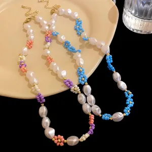 Detail of handmade flower bead and irregular pearl necklace with gold-plated clasp