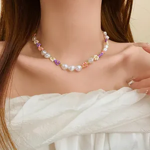 Detail of handmade colorful flower bead necklace with heart-shaped pearls on model
