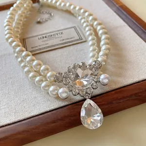 French style double-layer faux pearl necklace with rhinestone teardrop pendant.
