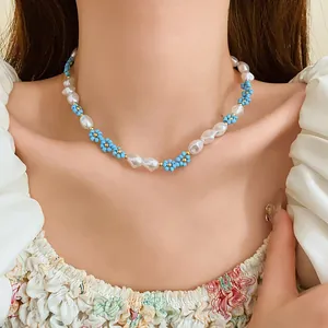 Close-up detail of a delicate floral seed bead and pearl choker necklace on a model's neck