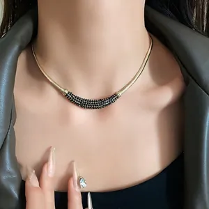 Elegant gold-toned choker necklace featuring a crystal-encrusted crescent moon pendant.