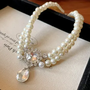 Close-up of French double-layer faux pearl necklace with teardrop rhinestone pendant.