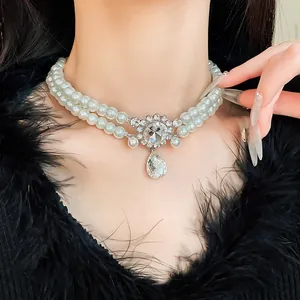 Close-up of elegant double-layered pearl necklace with rhinestone teardrop pendant