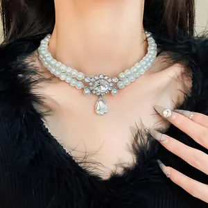 Close-up of double-layered faux pearl necklace with rhinestone water-drop pendant