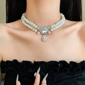 Close-up of elegant French double-layer pearl choker with rhinestone waterdrop pendant