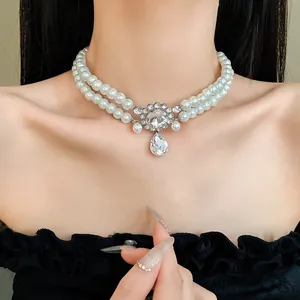 Detail of a French double-layer faux pearl necklace with a sparkling rhinestone water drop pendant.