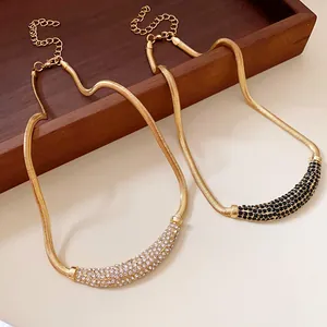 Elegant gold snake chain necklace with crescent pendant encrusted with rhinestones