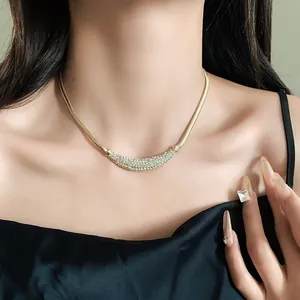 Detail shot of elegant pavé crescent necklace on model, gold chunky chain style