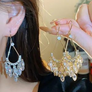Close-up of 18k gold plated zircon waterdrop tassel earrings for an elegant look.