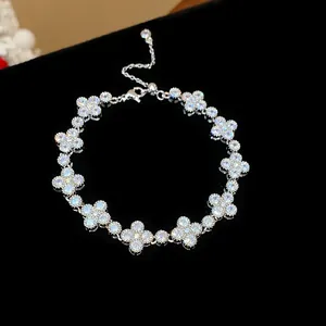 Close-up of a sparkling silver bracelet featuring intricate floral designs with cubic zirconia.