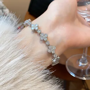 Detail shot of a sparkling zircon flower bracelet on a wrist with elegant styling